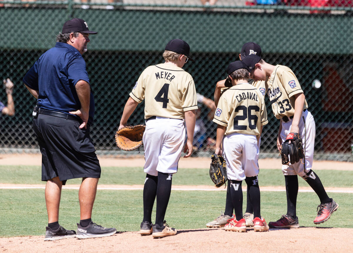 Paseo Verde's head coach Bill Senne discusses with his players during the Little League Basebal ...
