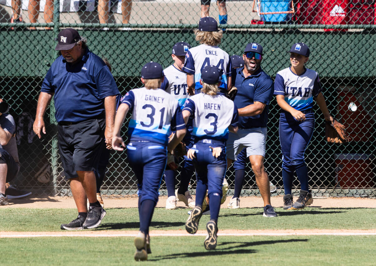 Paseo Veda's head coach Bill Senne, left, walks past Utah-Snow Canyon players as they celebrate ...