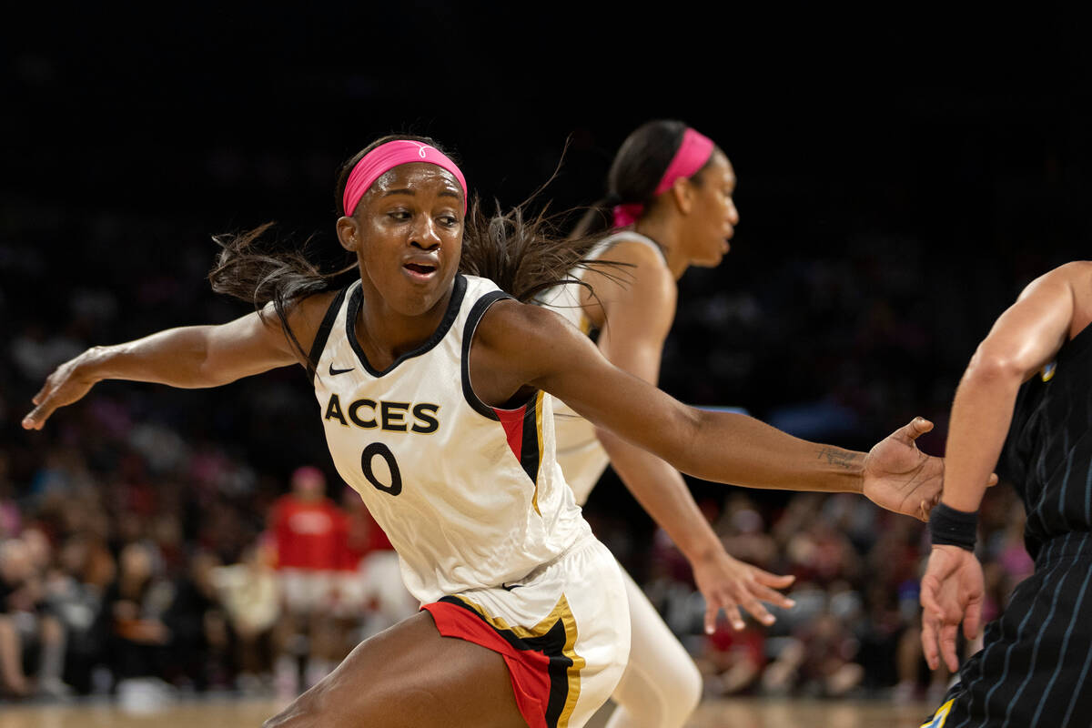 Las Vegas Aces guard Jackie Young (0) reaches to defend against Chicago Sky guard Courtney Vand ...
