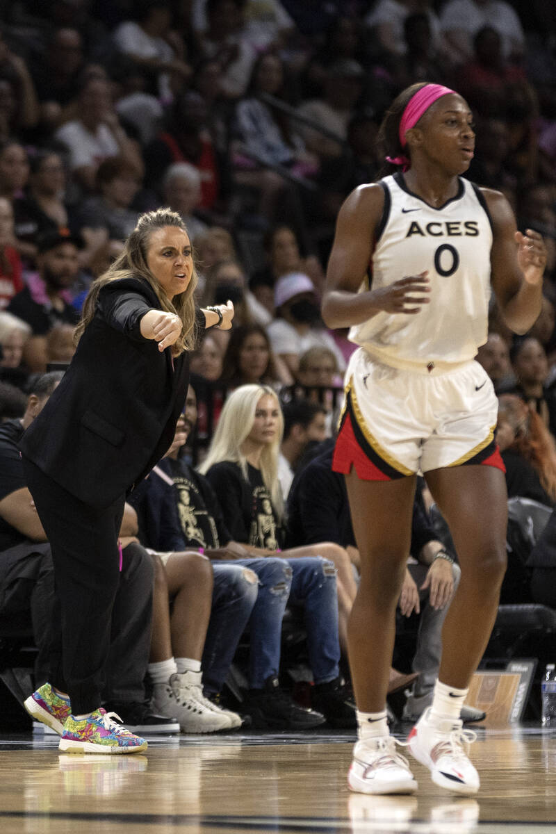 Las Vegas Aces head coach Becky Hammon shouts from the sidelines while guard Jackie Young (0) g ...
