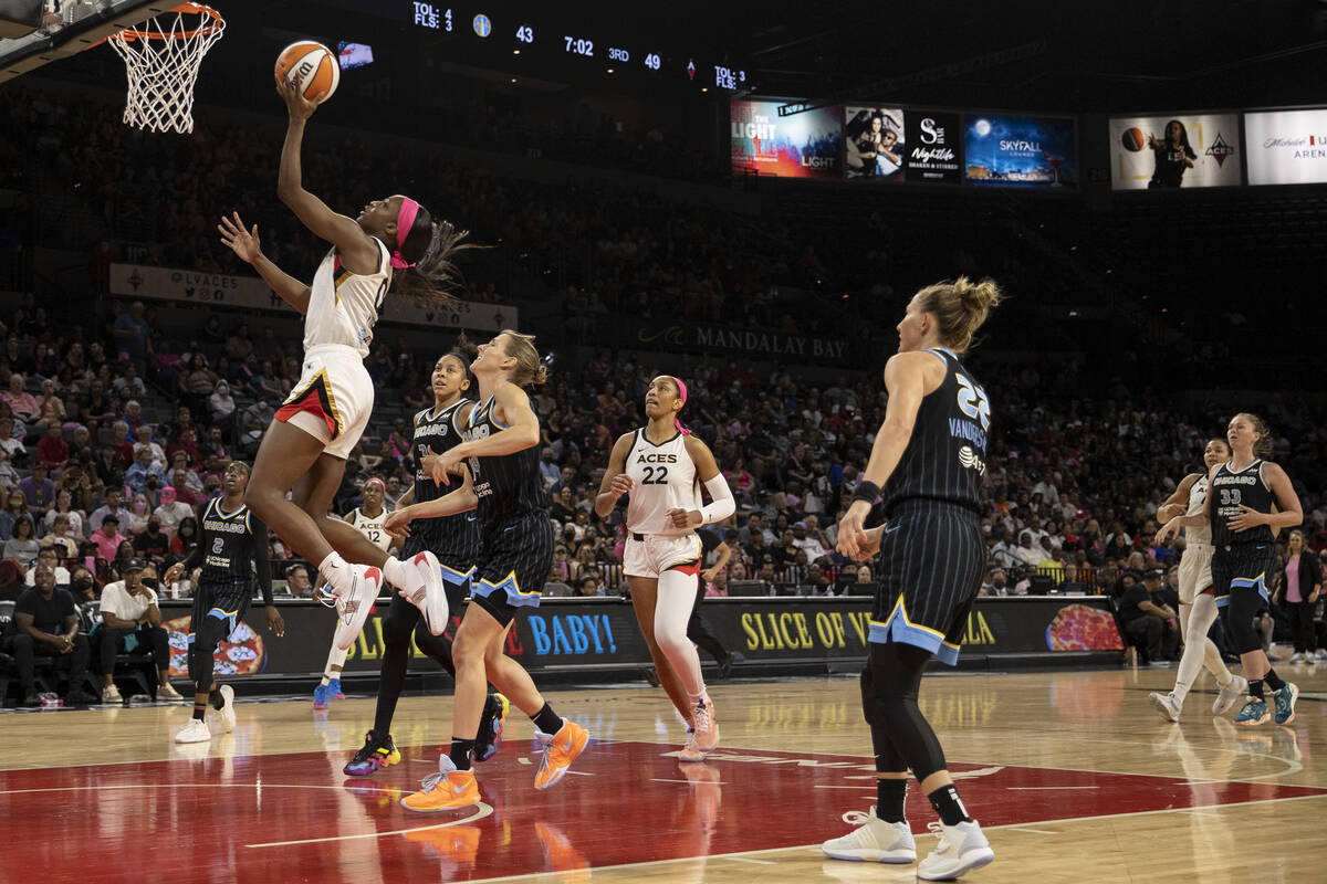 After stealing possession, Las Vegas Aces guard Jackie Young (0) reaches the basket for a layup ...