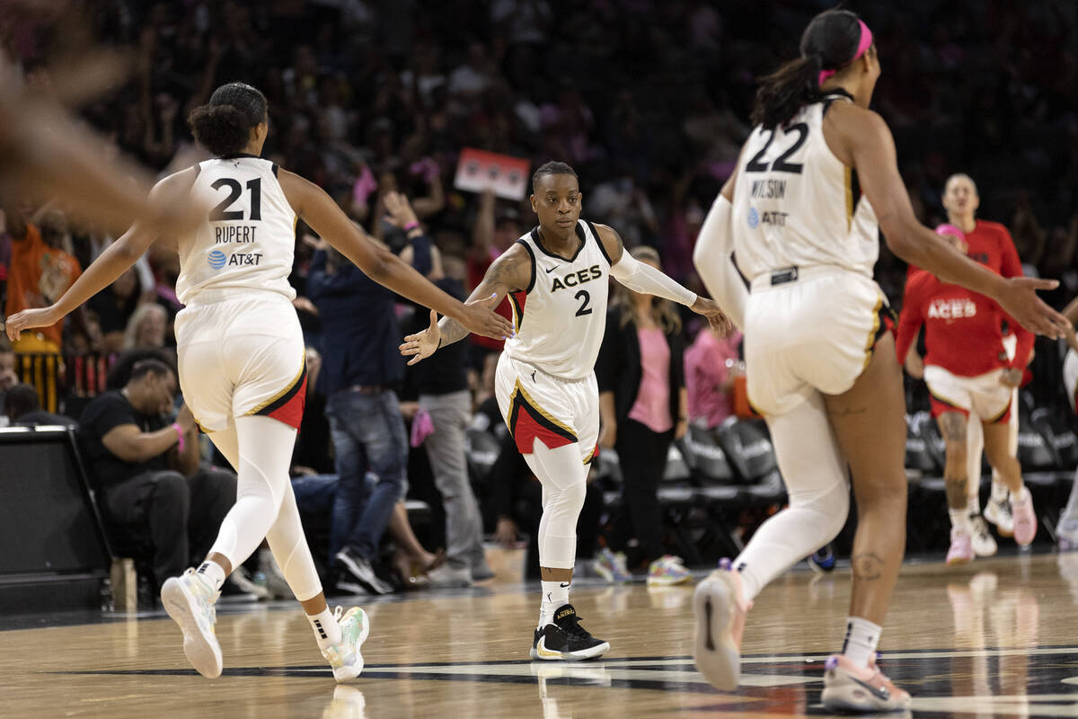 Las Vegas Aces guard Riquna Williams (2) is congratulated by center Iliana Rupert (21) and forw ...