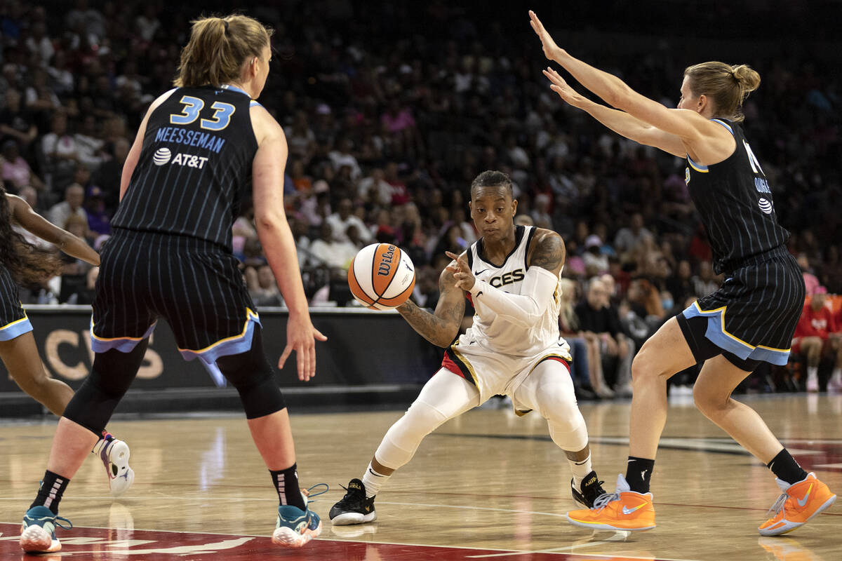 Las Vegas Aces guard Riquna Williams, center, looks to pass while Chicago Sky forward Emma Mees ...