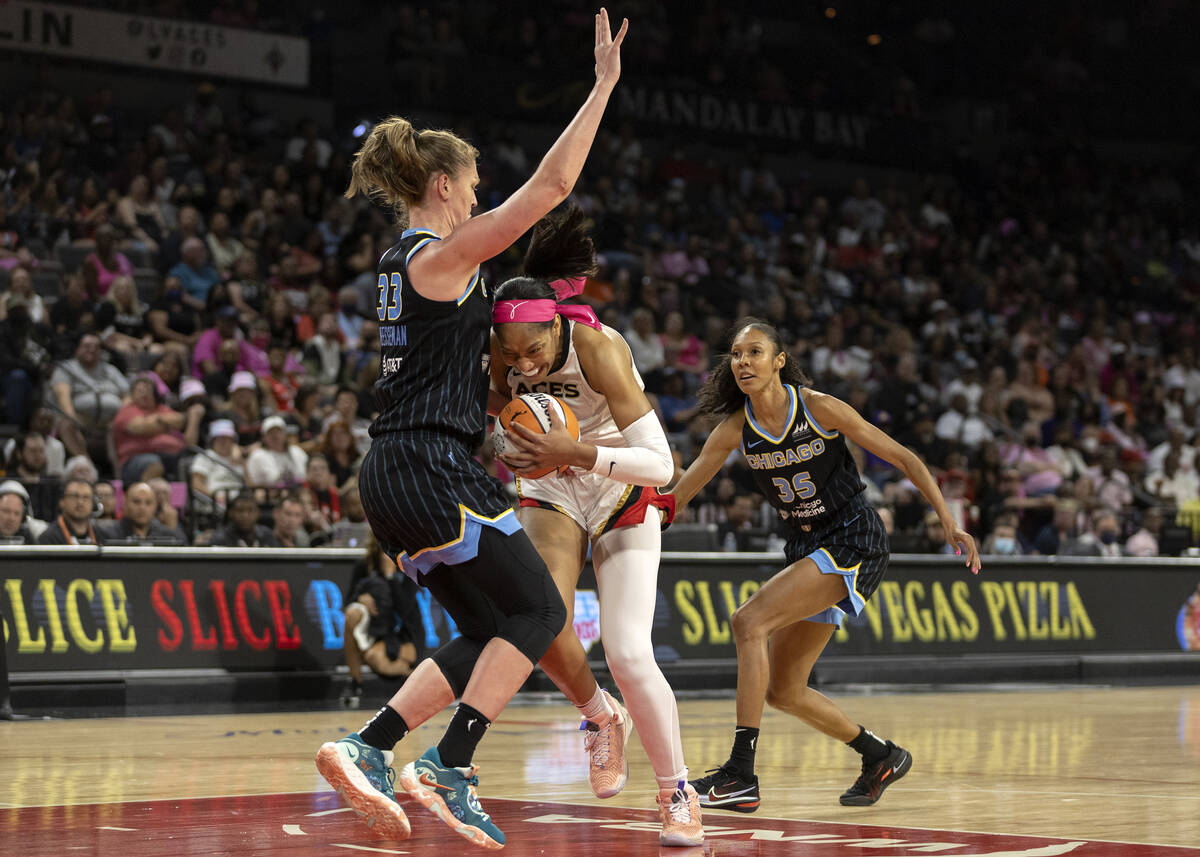 Las Vegas Aces forward A'ja Wilson (22) struggles past Chicago Sky forward Emma Meesseman (33) ...