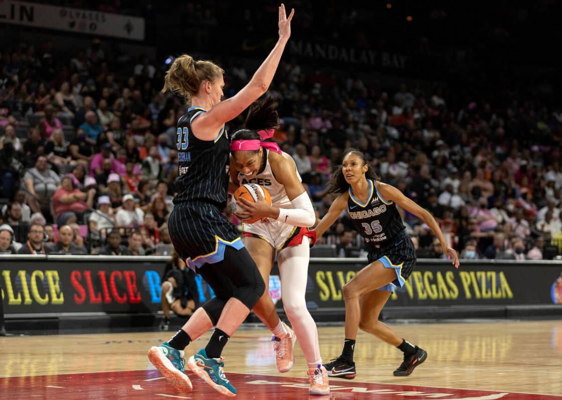 Las Vegas Aces forward A'ja Wilson (22) struggles past Chicago Sky forward Emma Meesseman (33) ...