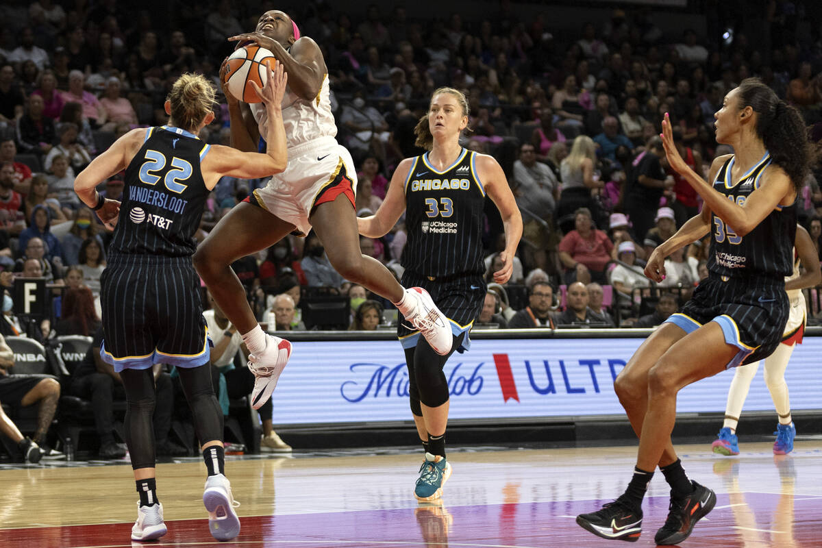 Las Vegas Aces guard Jackie Young (0) jumps to shoot against Chicago Sky guard Courtney Vanders ...