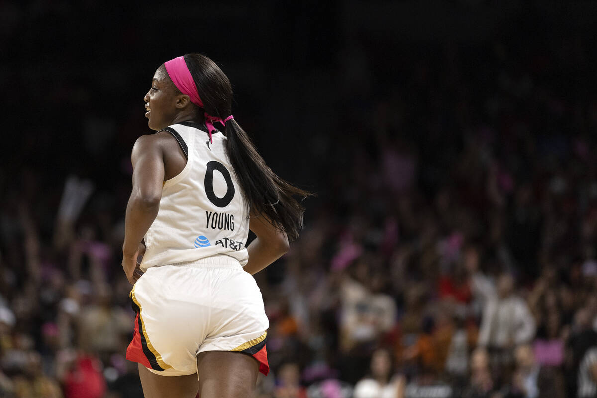 Las Vegas Aces guard Jackie Young (0) looks back with a smile after scoring against the Chicago ...