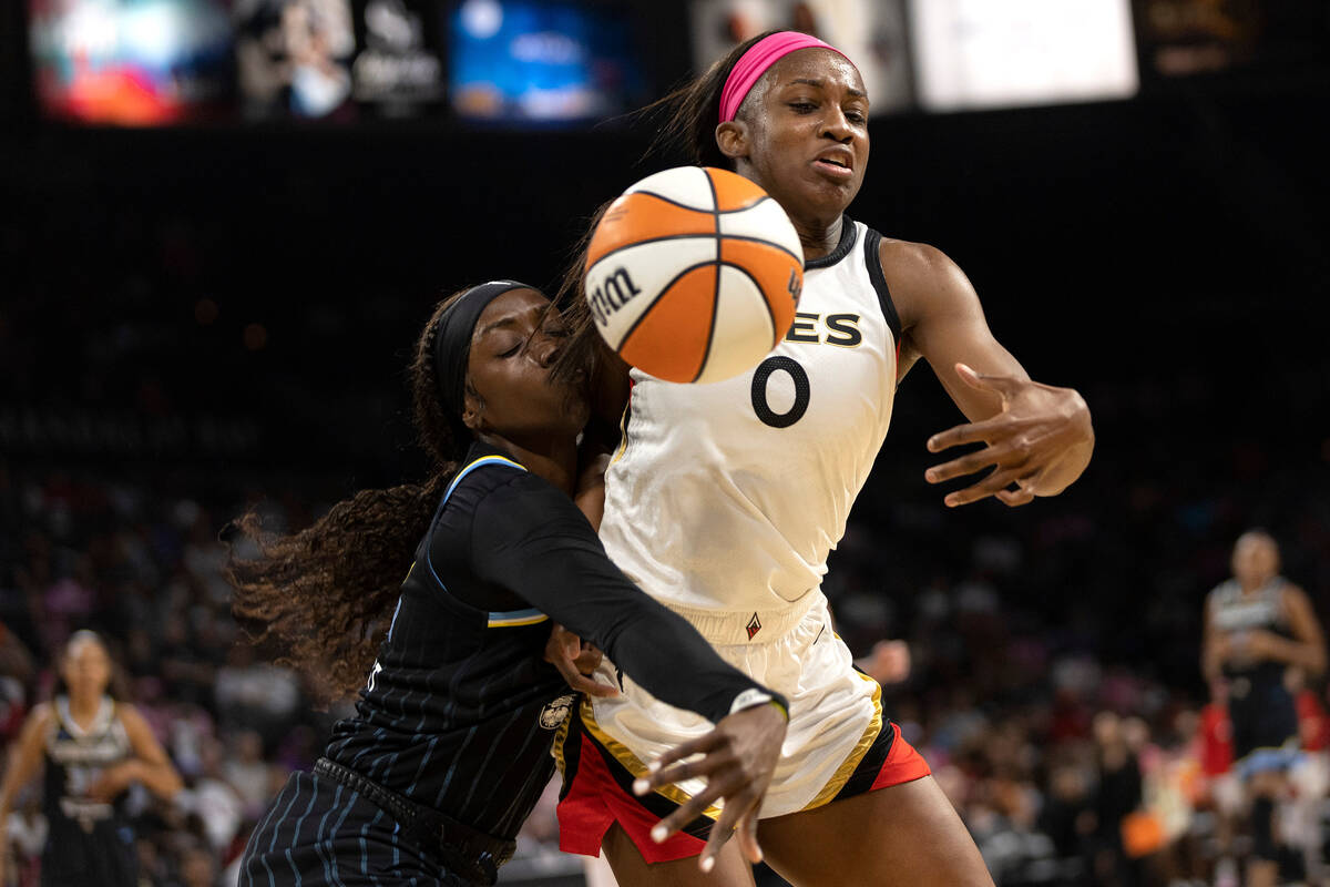 Las Vegas Aces guard Jackie Young (0) and Chicago Sky guard Kahleah Copper (2) collide while tr ...