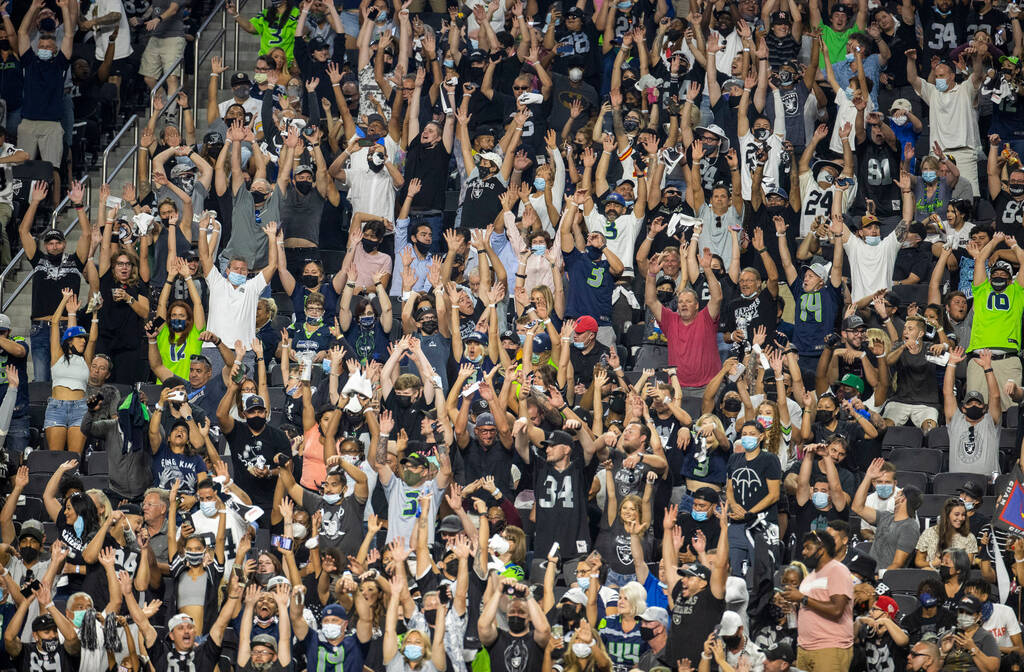Fans do the wave during the third quarter of the Raiders home opening pre-season NFL football g ...
