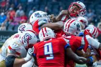 Quad City Steamwheelers quarterback E.J. Hilliard Jr. (12) goes over the top of the Northern Ar ...