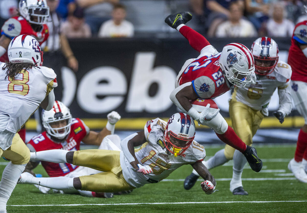 Northern Arizona Wranglers running back Israel Tucker (22) is upended during a run by Quad City ...