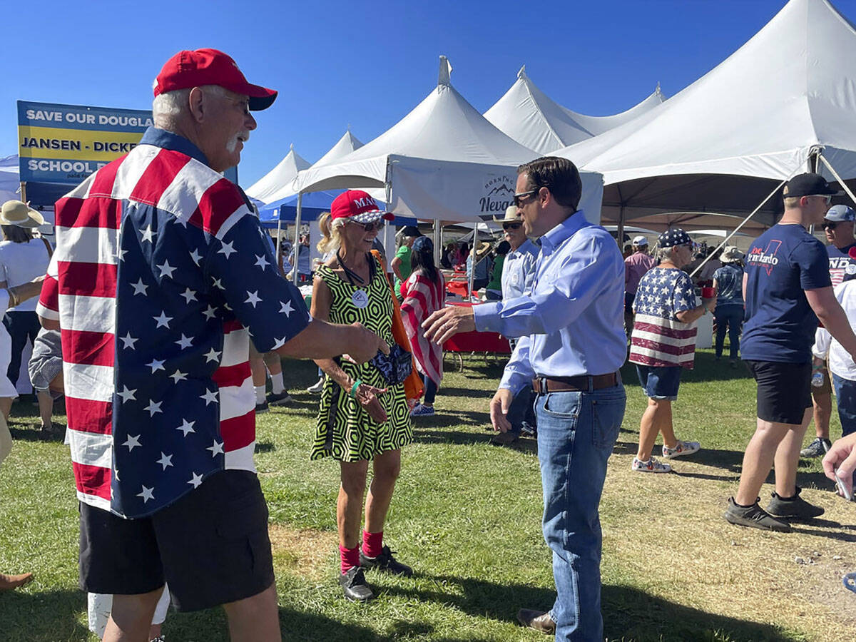 Republican Nevada Senate candidate Adam Laxalt, right, takes pictures with supporters at the se ...
