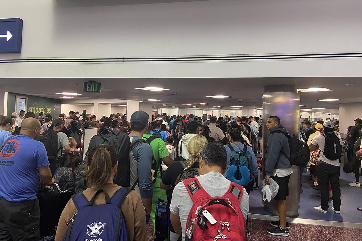 Travelers are shown on August 14, 2022, leaving the terminal to re-enter through security at Ha ...