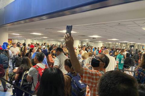 Travelers are held up at Harry Reid International Airport in Las Vegas on August 14, 2022. (Col ...