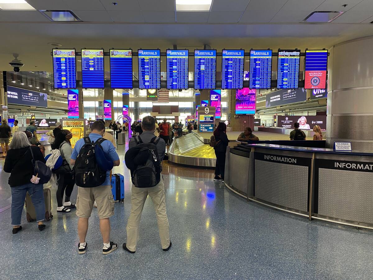 Travelers are held up at Harry Reid International Airport in Las Vegas on August 14, 2022.