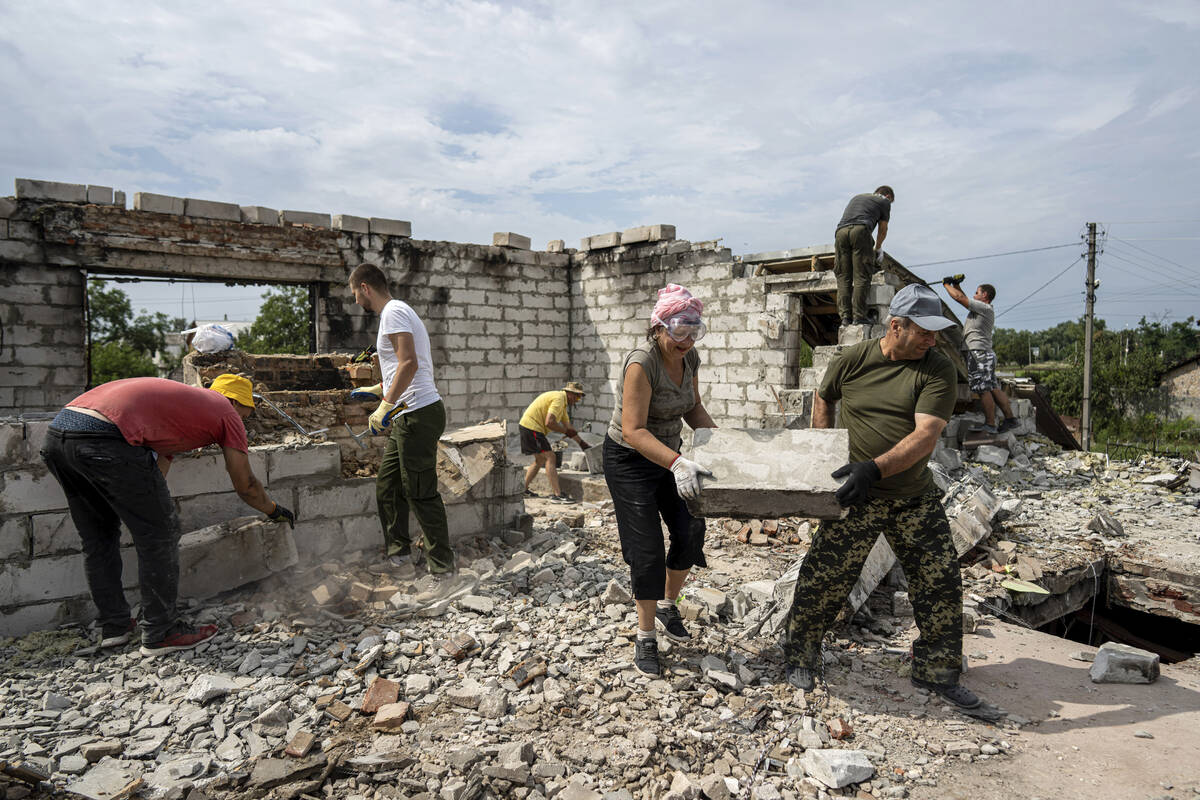 Volunteers clear rubble on the second floor of Zhanna and Serhiy Dynaeva's house which was dest ...