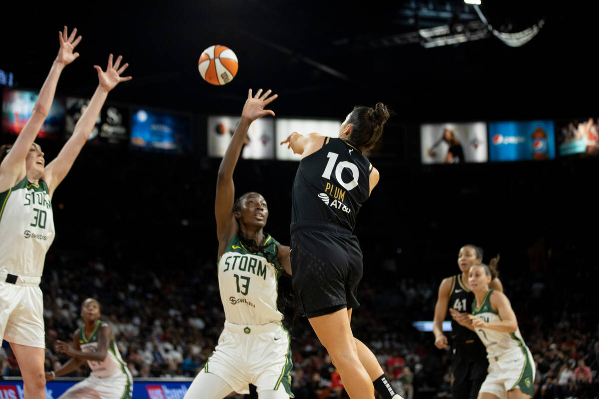 Aces guard Kelsey Plum (10) makes a pass over Seattle's Ezi Magbegor (13) in the first half of ...