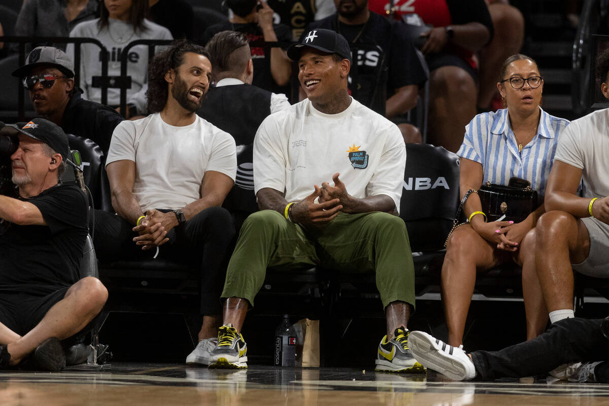 Las Vegas Raiders tight end Darren Waller, center, watches the Aces take on the Seattle Storm a ...