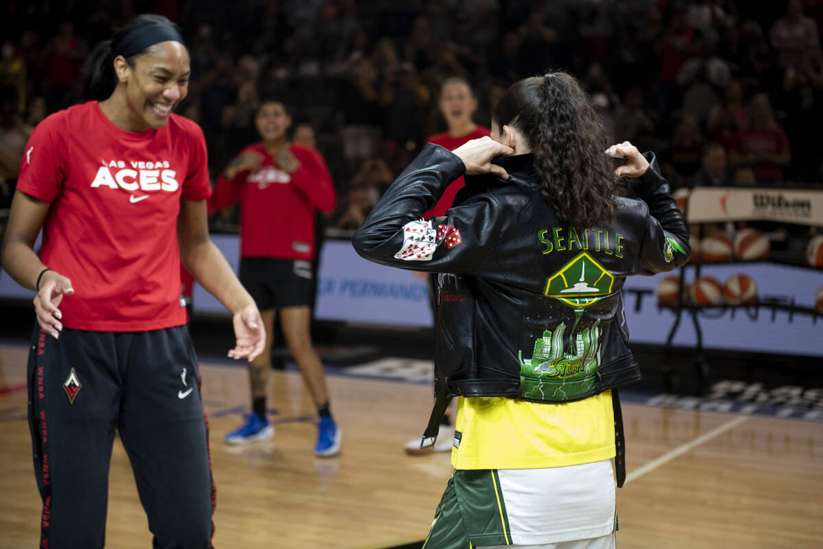 A'ja Wilson, left, presents Sue Bird with a custom leather jacket before the final regular seas ...