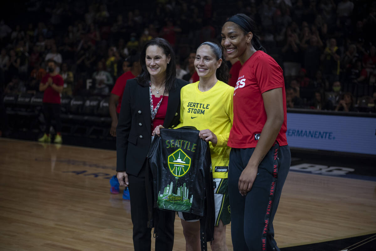 Jennifer Azzi, left, and A'ja Wilson present Sue Bird with a custom leather jacket before the f ...