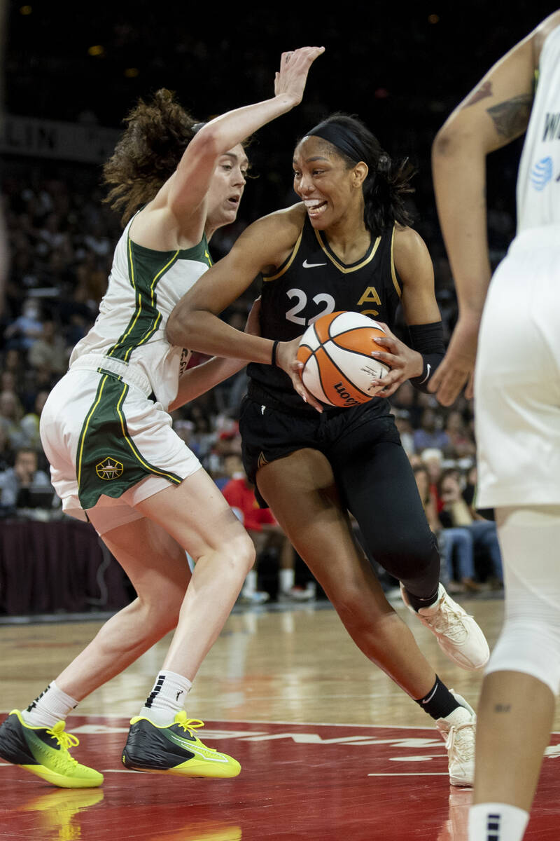 Aces forward A'ja Wilson (22) drives against Storm forward Breanna Stewart (30) as the Las Vega ...
