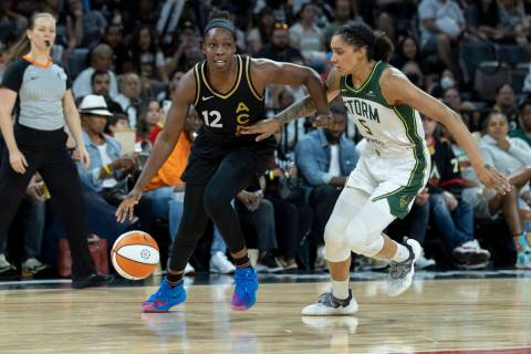 Las Vegas Aces guard Chelsea Gray (12) drives past Seattle's Gabby Williams (5) in the last reg ...