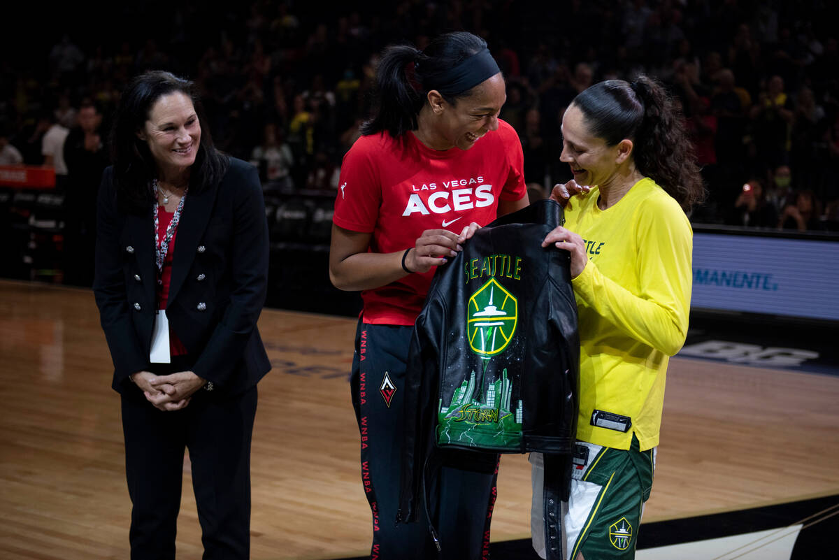 Jennifer Azzi, left, and A'ja Wilson present Sue Bird with a custom leather jacket before the f ...