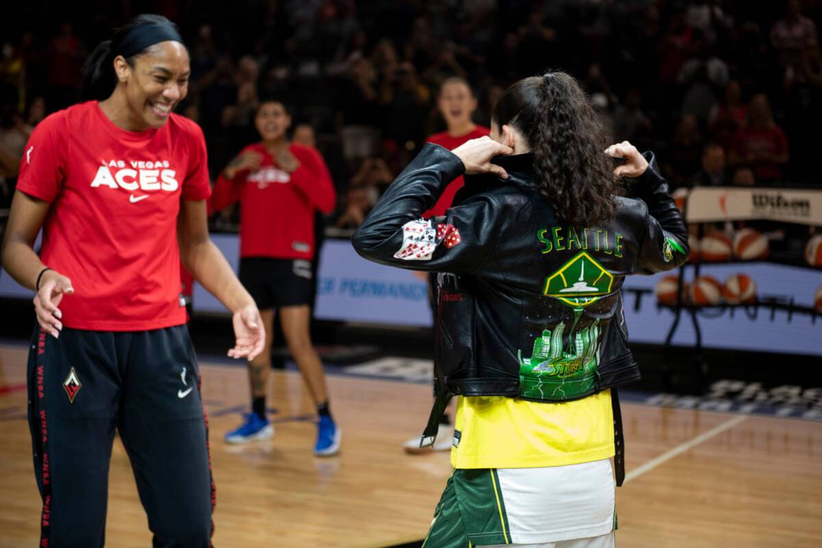 A'ja Wilson, left, presents Sue Bird with a custom leather jacket before the final regular seas ...