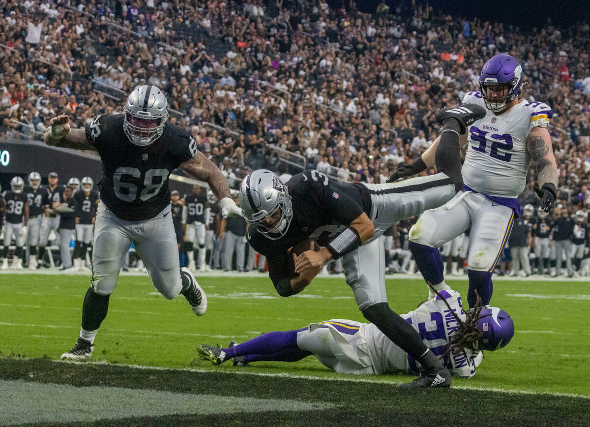 Raiders quarterback Jarrett Stidham (3) rushes into the end zone for a touchdown leaping over M ...