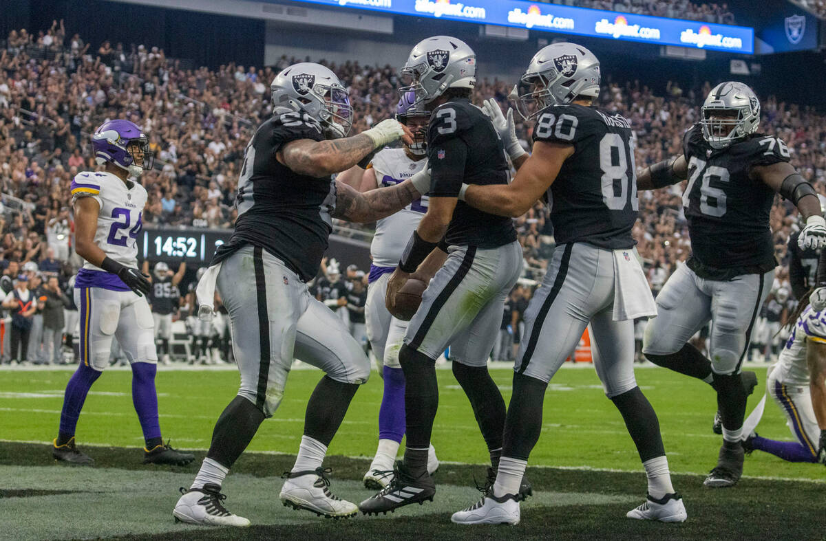 Raiders quarterback Jarrett Stidham (3) is congratulated for his touchdown score with center An ...