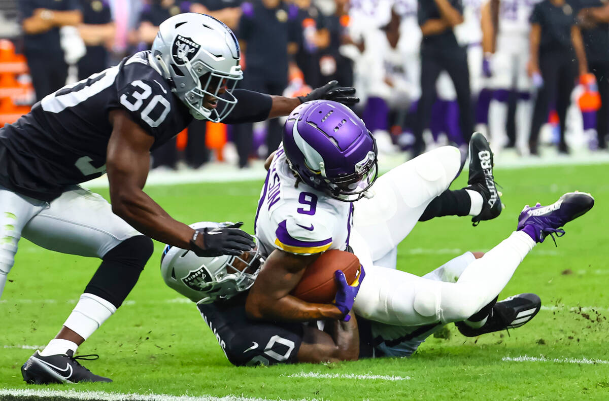 Minnesota Vikings wide receiver Trishton Jackson (9) gets tackled by Raiders cornerback Darius ...