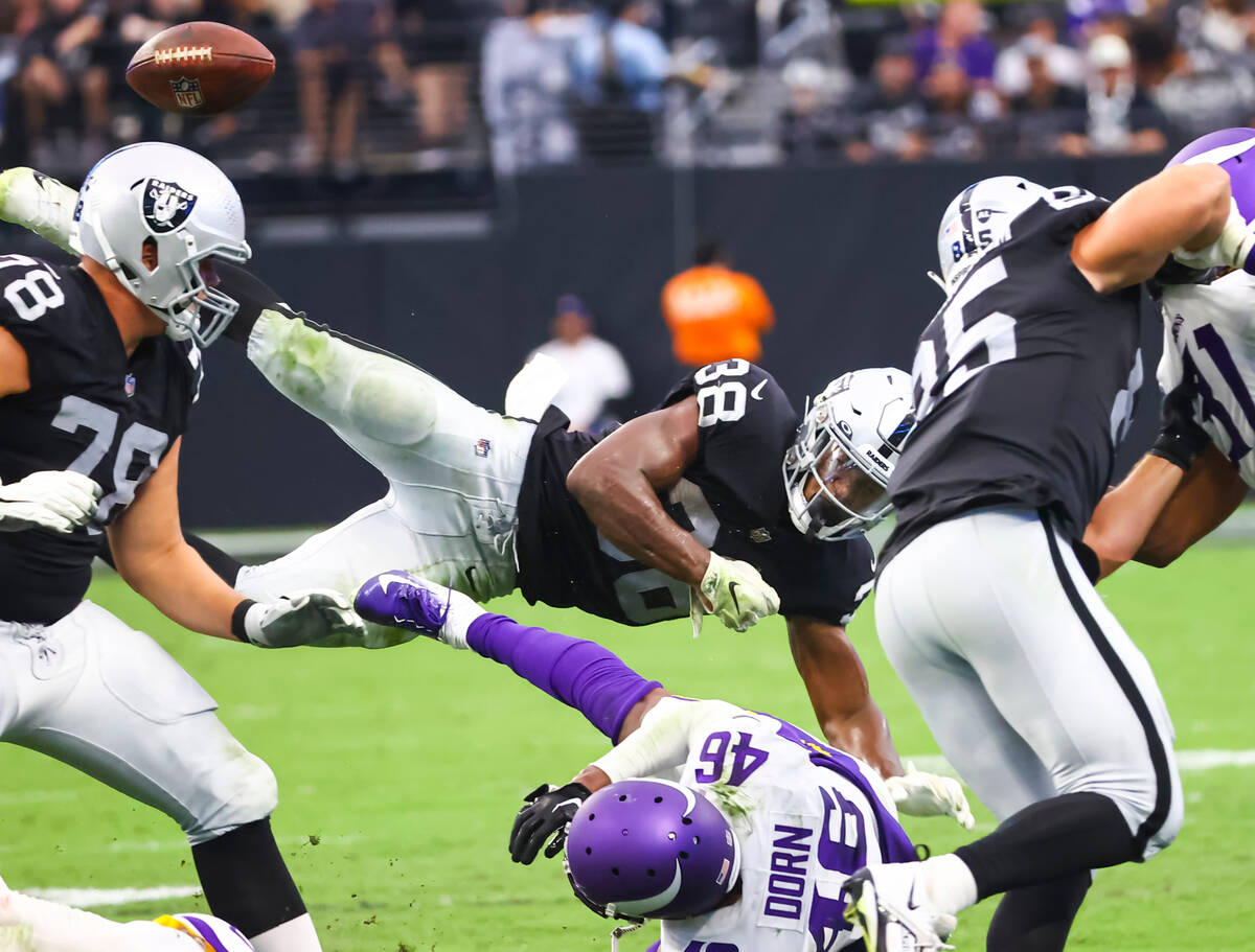 Raiders running back Brittain Brown (38) fumbles the ball after a hit from Minnesota Vikings sa ...