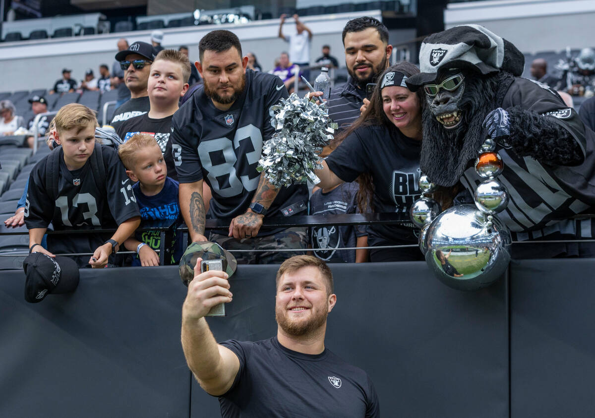 Raiders offensive tackle Kolton Miller (74) takes a selfie with fans before the Raiders versus ...