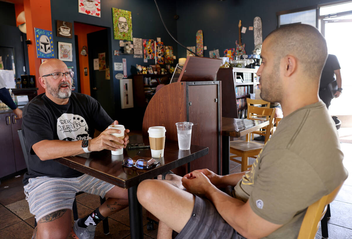 Harry Fagel, left, and Shakeel Abdal-Karim drink coffee while studying at Grouchy John's Coffee ...