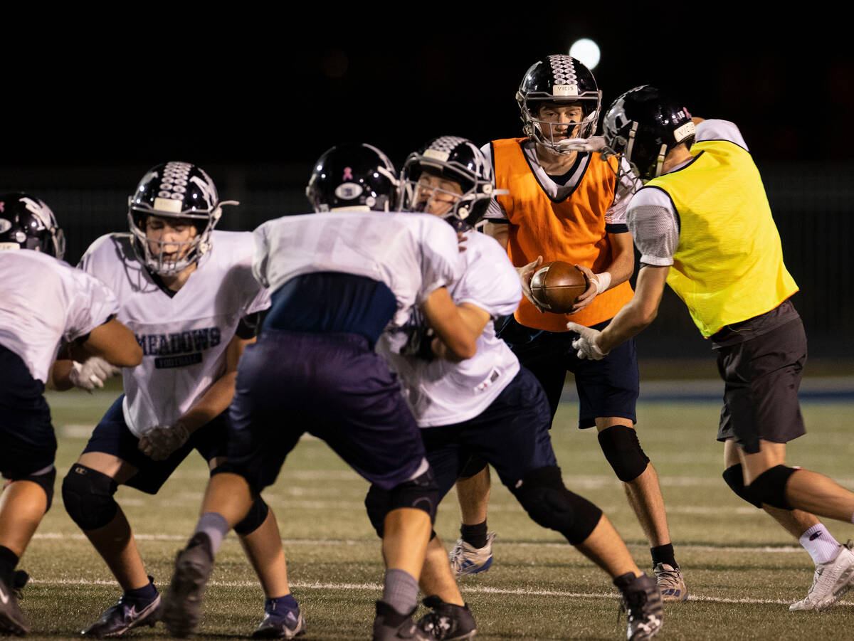 In this Nov. 16, 2021, file photo, The Meadows High School quarterback Sean Gosse hands off the ...
