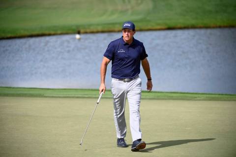 Phil Mickelson reacts to a putt on the eighth green during the first round of the Arnold Palmer ...