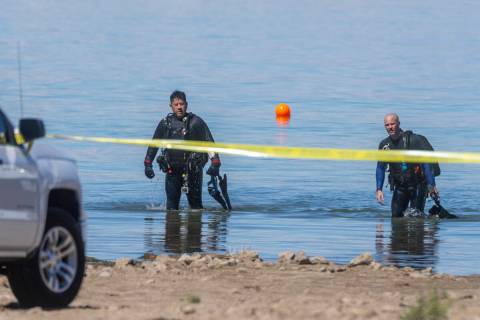 Divers leave the water as authorities are assessing what were described as skeletal remains fou ...