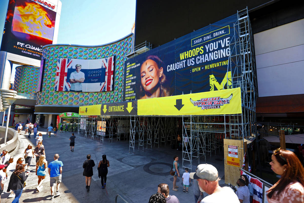 People walk past scaffolding at the Miracle Mile Shops under renovation at Planet Hollywood on ...