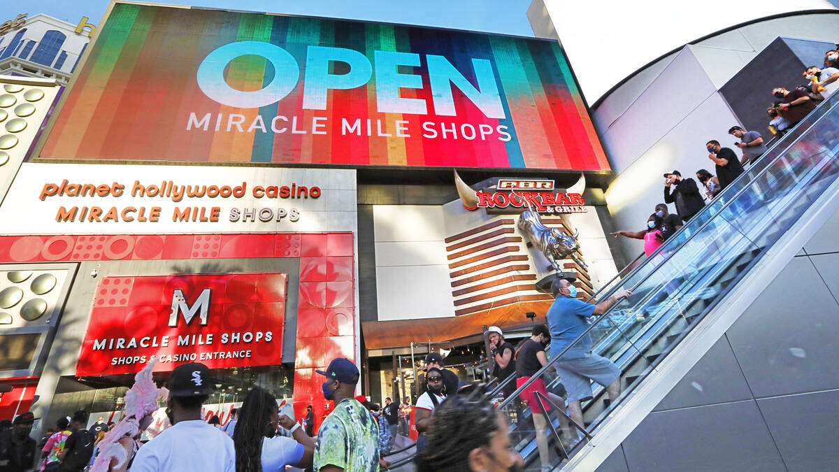 People walk along the Las Vegas Strip near the Miracle Mile Shop, Friday, March 19, 2021, in La ...