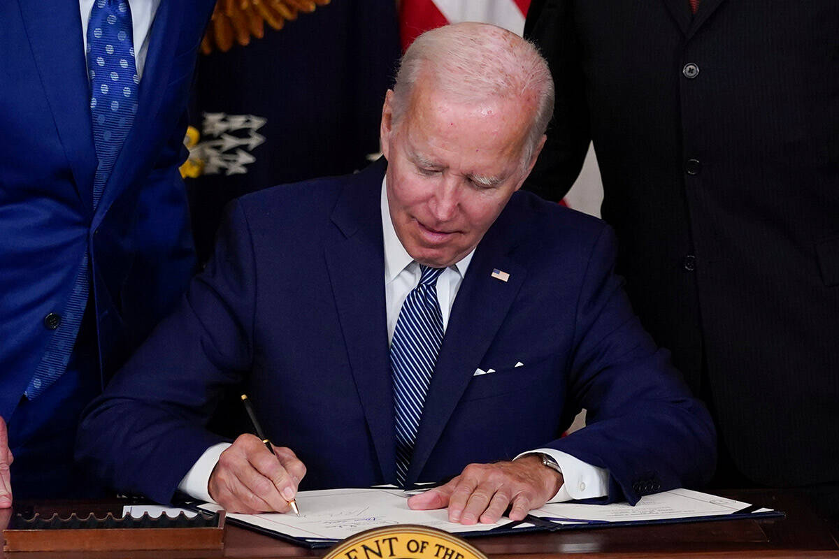 President Joe Biden signs the Democrats' landmark climate change and health care bill in the St ...