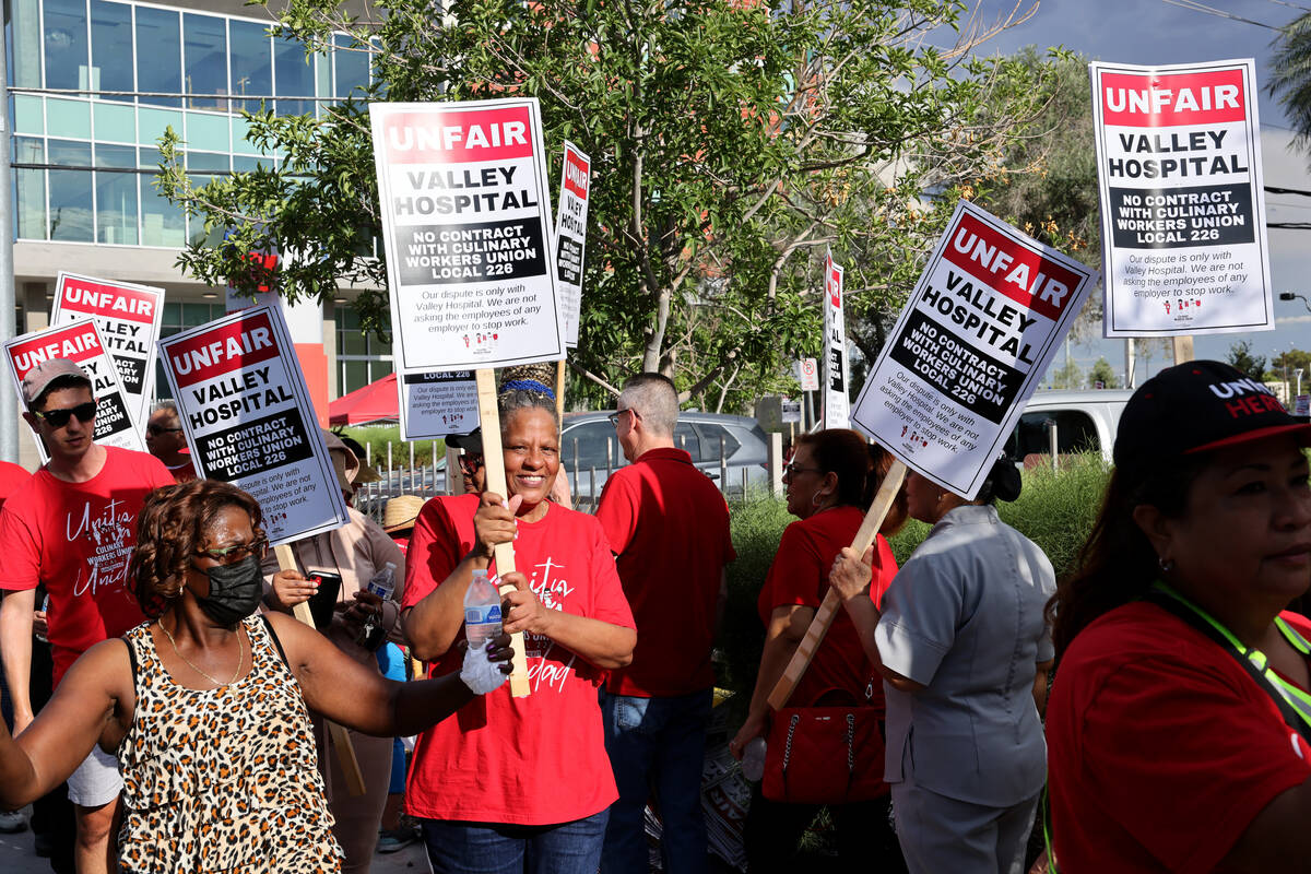 Members of the Culinary Union, including 40-year employee Betty Williams, center, and supporter ...