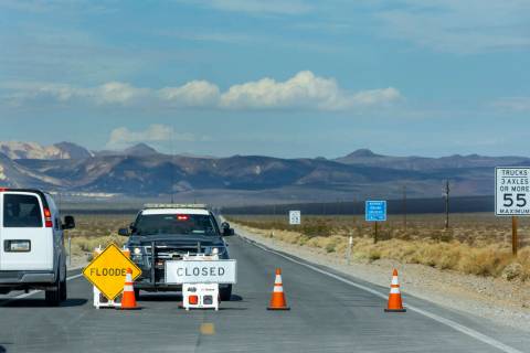 A roadblock remains on State Route 190 leading into Death Valley National Park, following monso ...