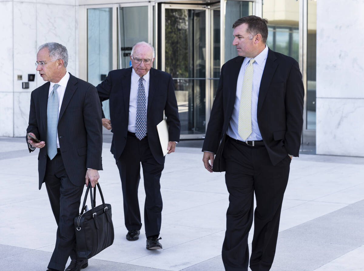 FBI agent Scott Carpenter, 40, right, leaves the Lloyd George U.S. Courthouse with his attorney ...