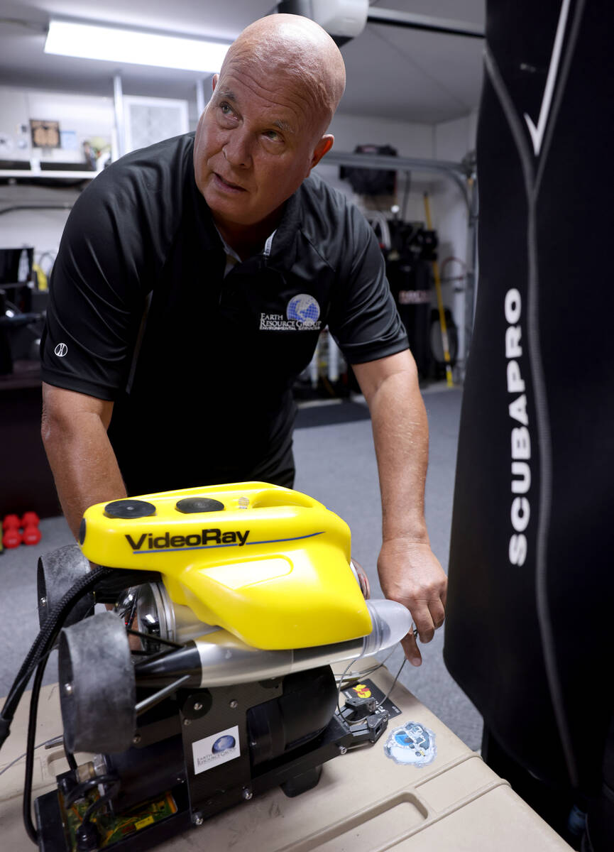 Technical diver Steve Schafer shows an underwater remote-operated vehicle at his Henderson home ...