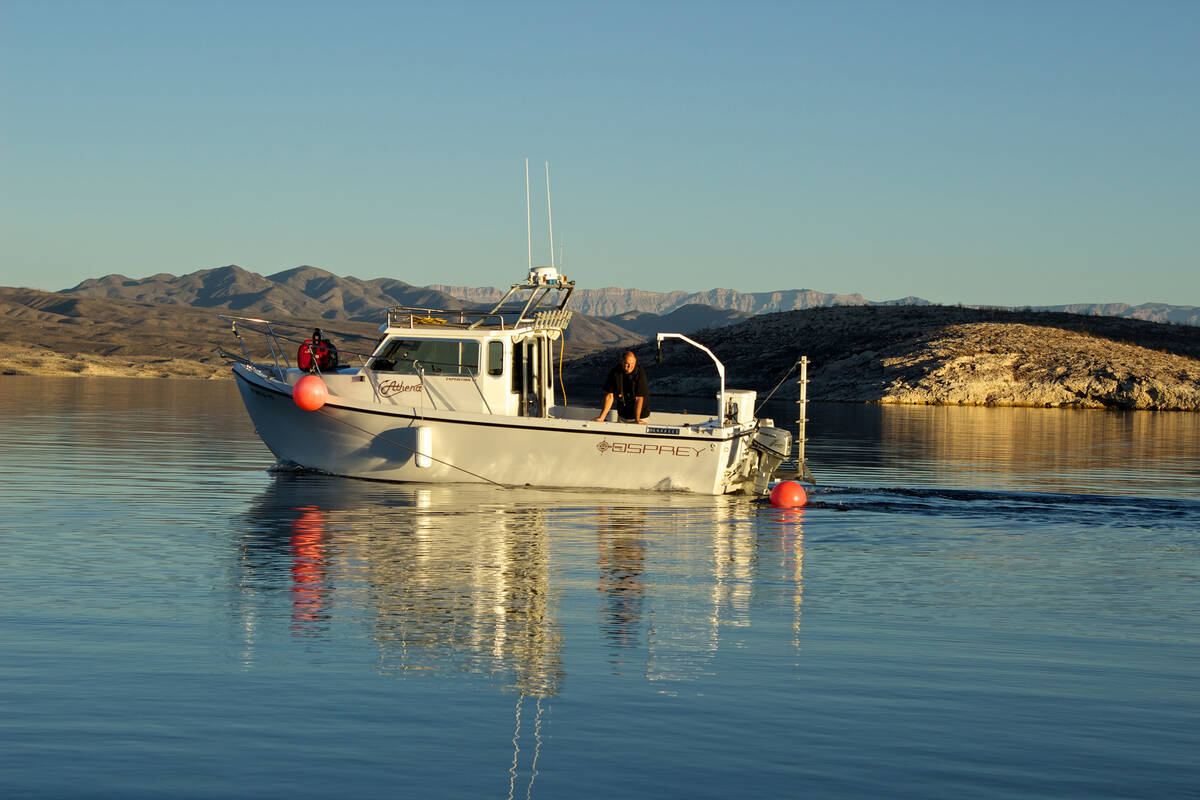 Steve Schafer and his co-workers operate a boat used to search for missing persons on Lake Mead ...