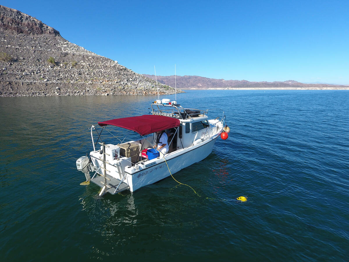 Steve Schafer and his co-workers operate a boat used to search for missing persons on Lake Mead ...