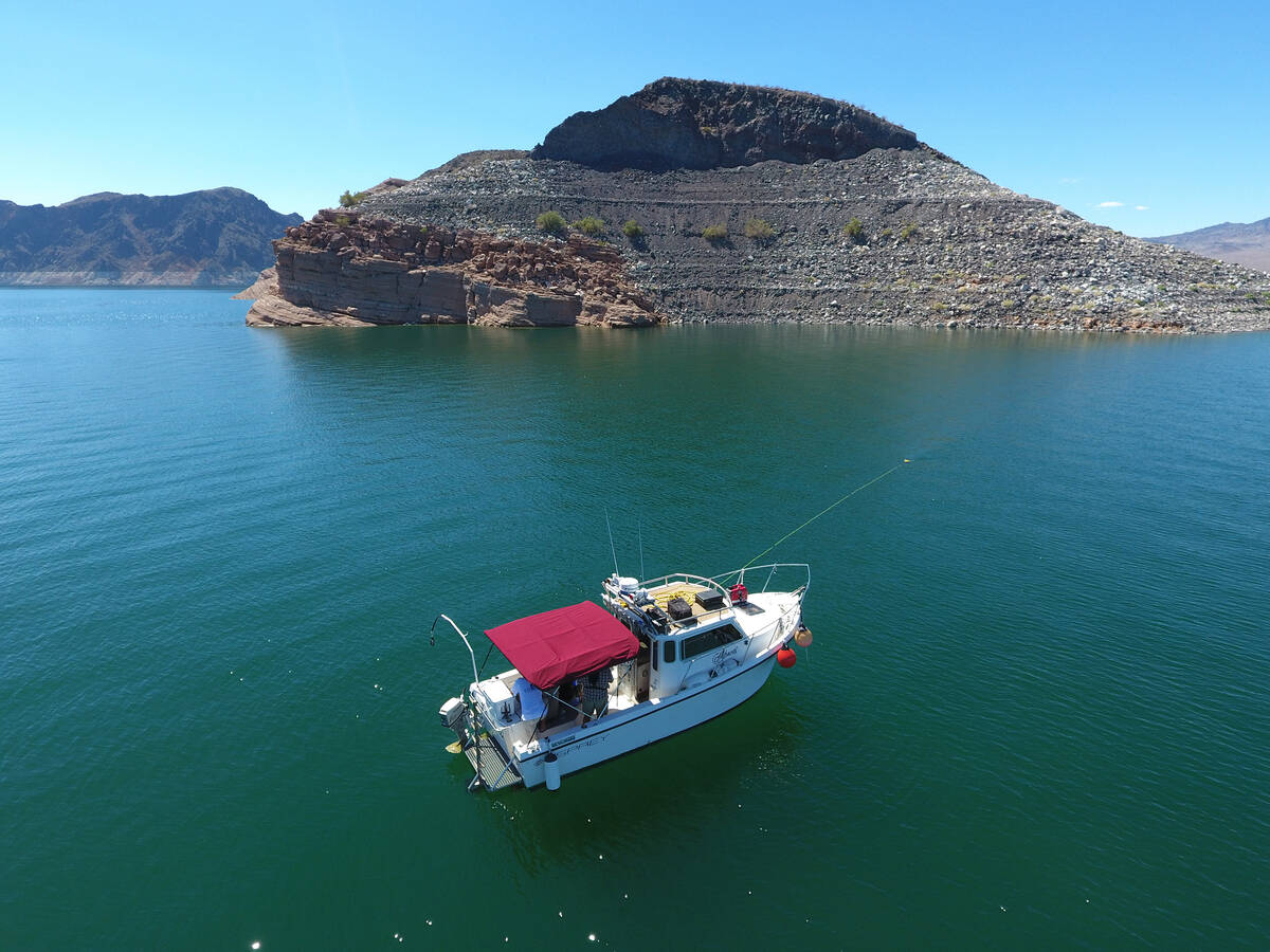 Steve Schafer and his co-workers operate a boat to search for missing persons on Lake Mead. (Ph ...