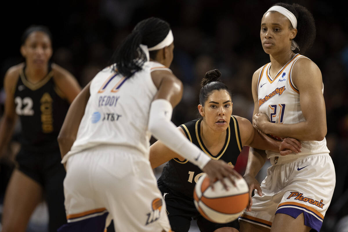 Las Vegas Aces guard Kelsey Plum (10) defends Phoenix Mercury forward Brianna Turner (21) while ...