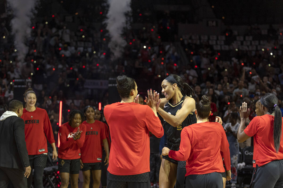 Las Vegas Aces forward A'ja Wilson (22) slaps hands with teammates as she takes the court durin ...