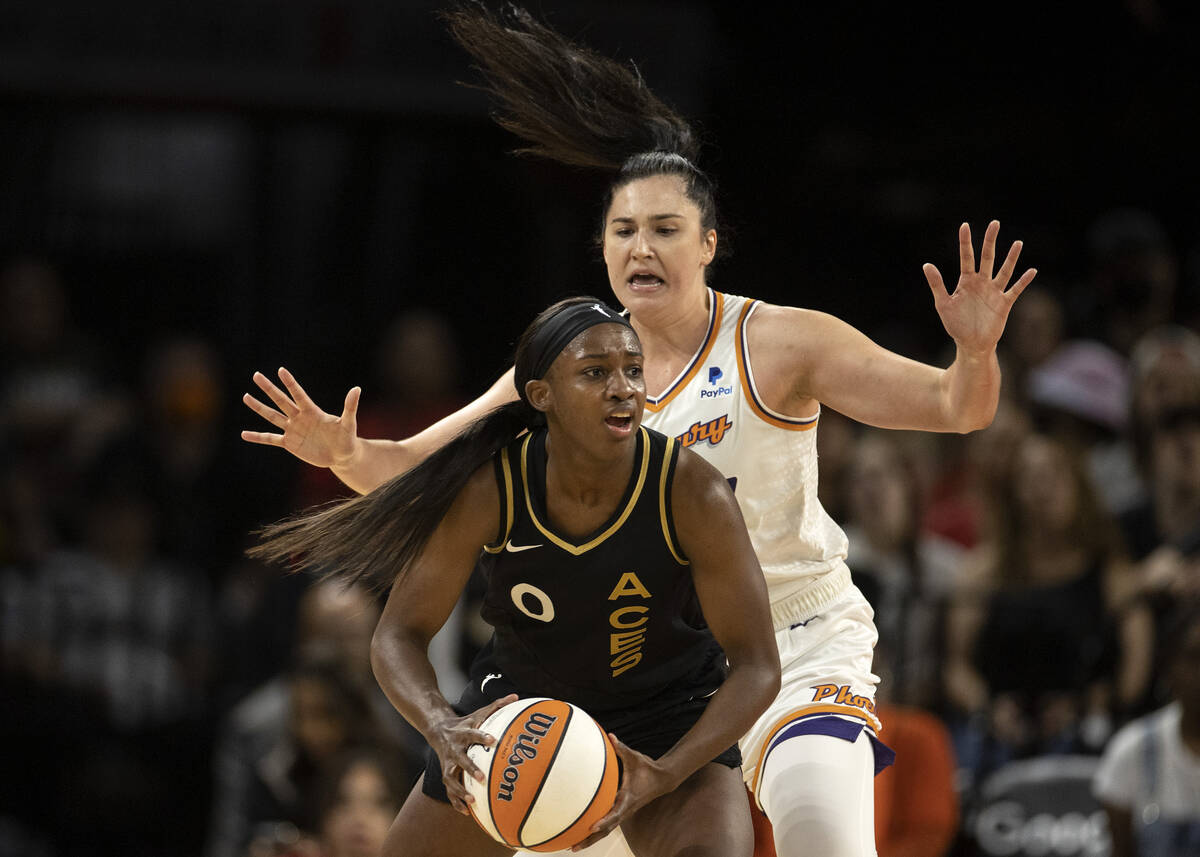 Las Vegas Aces guard Jackie Young (0) looks to pass while Phoenix Mercury center Megan Gustafso ...